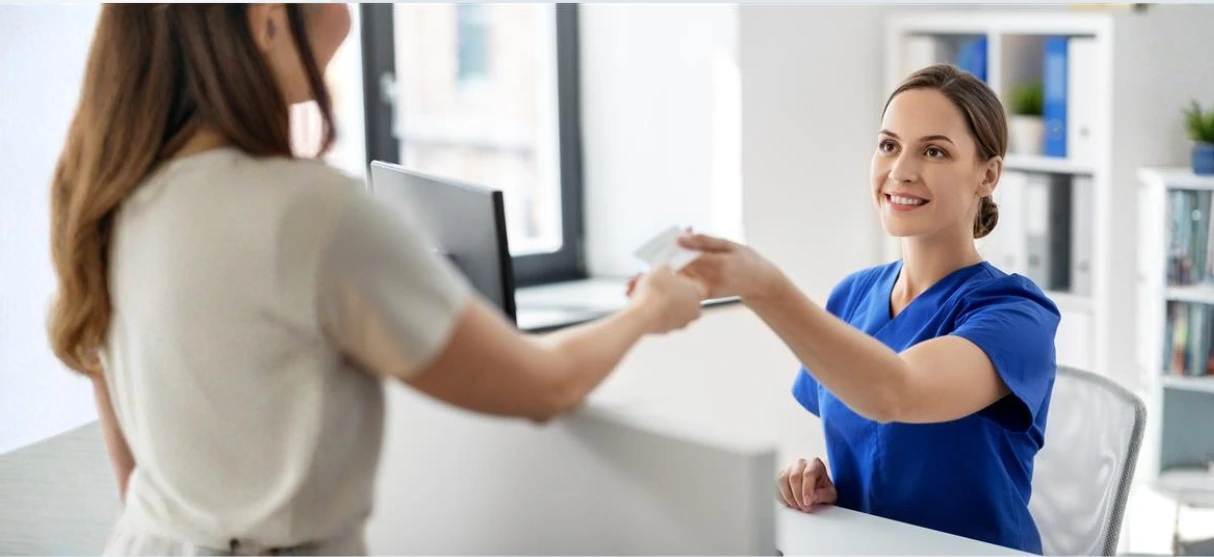 ZFA reicht Patientin Dokument – Infoveranstaltung Rezeptionsmanager Zahnarztpraxis IHK | Spitta Akademie